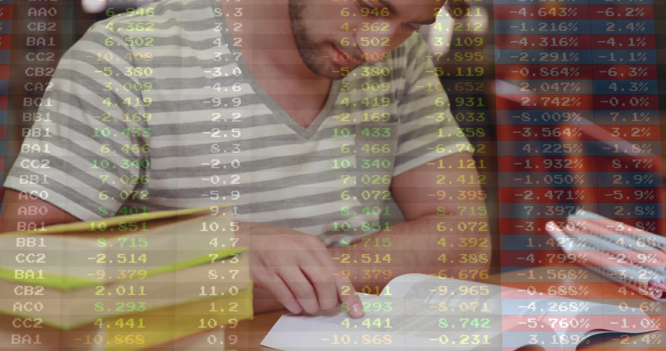 Male student reaching and opening finance book tracing text making notes with data overlay drifting