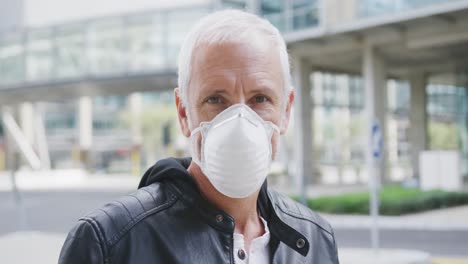 caucasian man out and about in the street wearing on a face mask against coronavirus