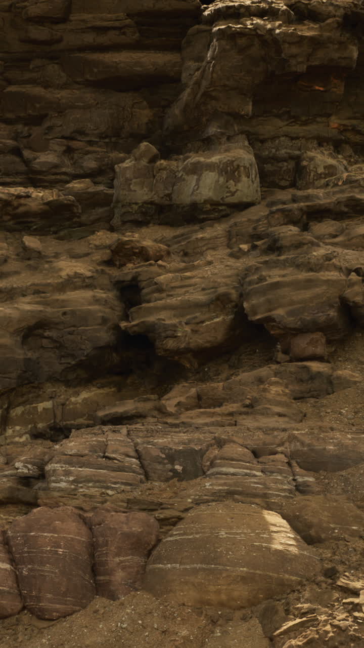 Large rock formations are visible at a remote desert location during daytime
