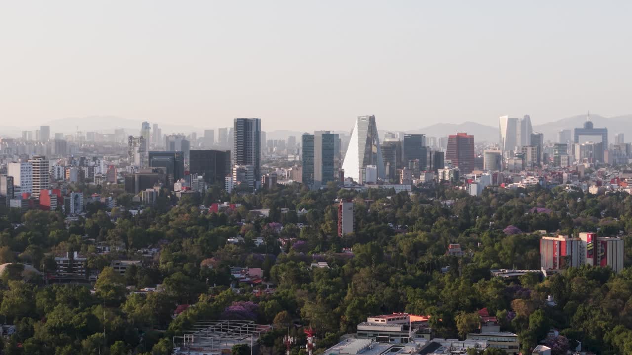 Drone aerial shot showing parallax effect on buildings at sunset in Mexico City