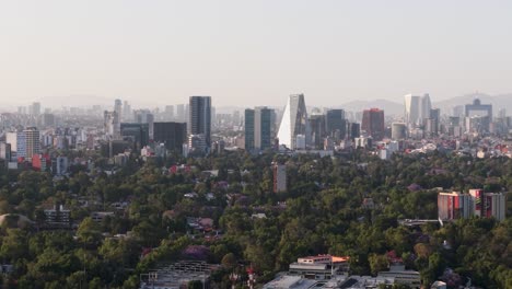 drone aerial shot showing parallax effect on buildings at sunset in mexico city