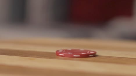 pan right close up of poker chip being spun by man