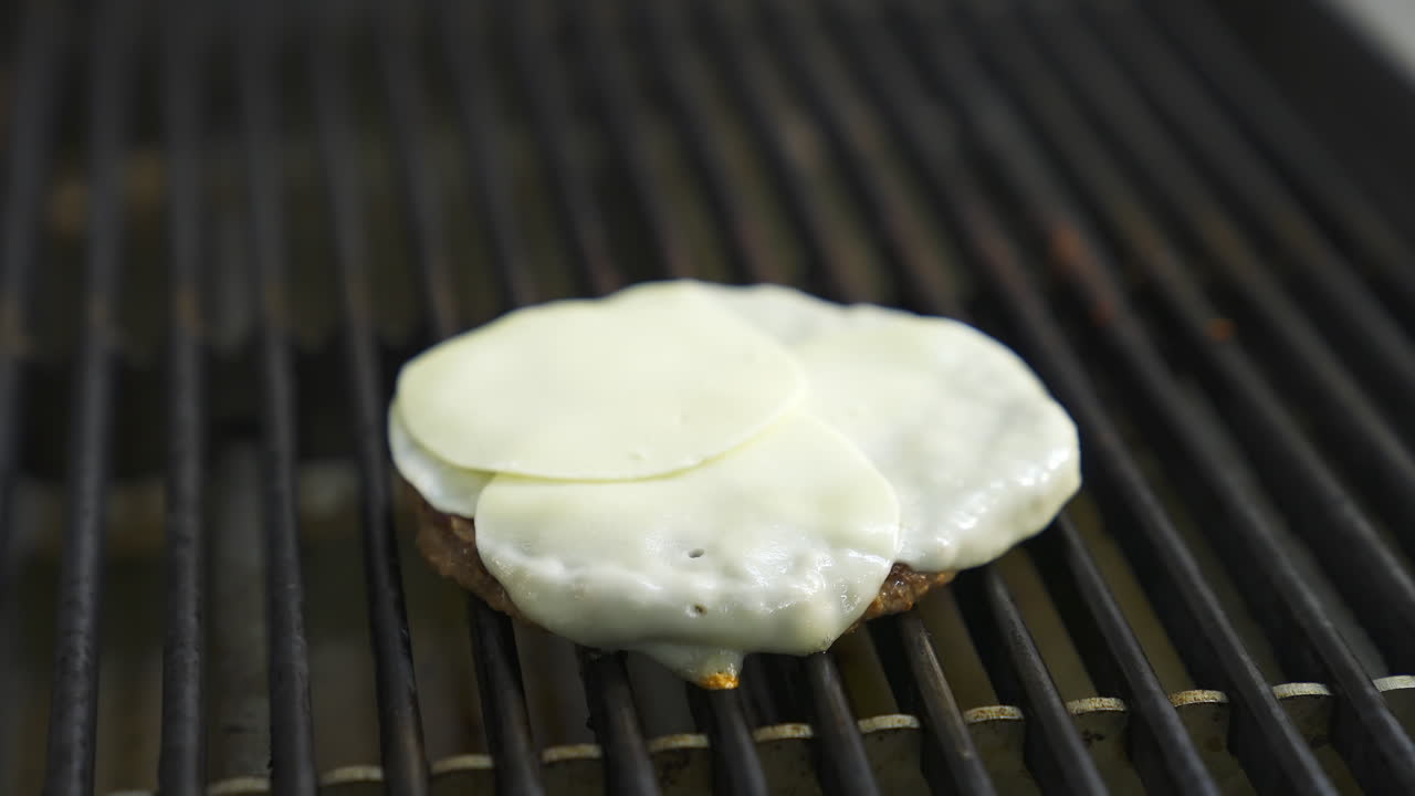 Cutlet for burger with egg on top are fried on a large grill. Fast food concept. Tasty video.