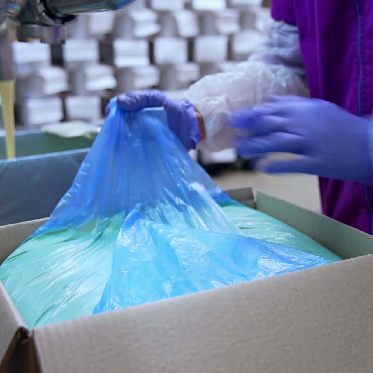 Filling of butter container. Butter poured into box at the creamery