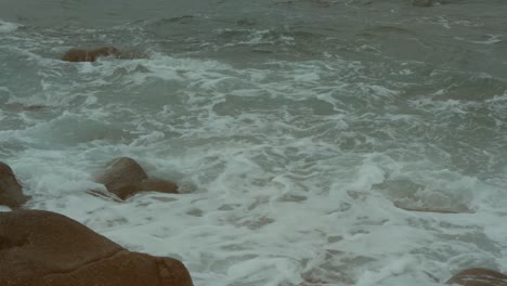 close-up-of-waves-splashing-against-the-rocky-shore