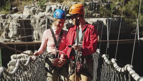 young caucasian couple walking in zip lining equipment