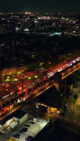 well-lit queensboro bridge carrying the road that leads to silvercup studios. billions of lights of neversleeping new york at night. vertical video
