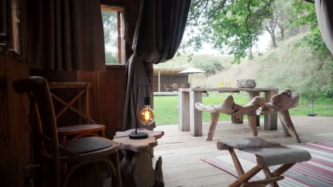 slow establishing shot of a wood cabin with ambient lighting