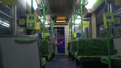 an empty tram rolls through melbourne, australia during the nightly coronavirus curfew that forces people to stay home and leaves the streets and public transport deserted