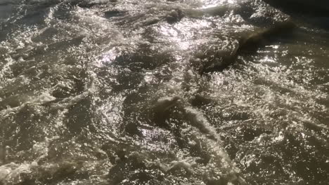 Extreme slow motion view of fast flowing stream of water in river