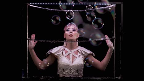 Model-girl-does-tricks-with-soap-bubbles-She-blows-a-lot-of-bubbles-towards-the-viewer