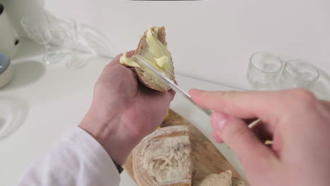 butter being spread on a slice of bread