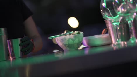 A-female-bartender-prepares-a-bowl-with-lemon-slices-to-prepare-cocktails-at-a-party