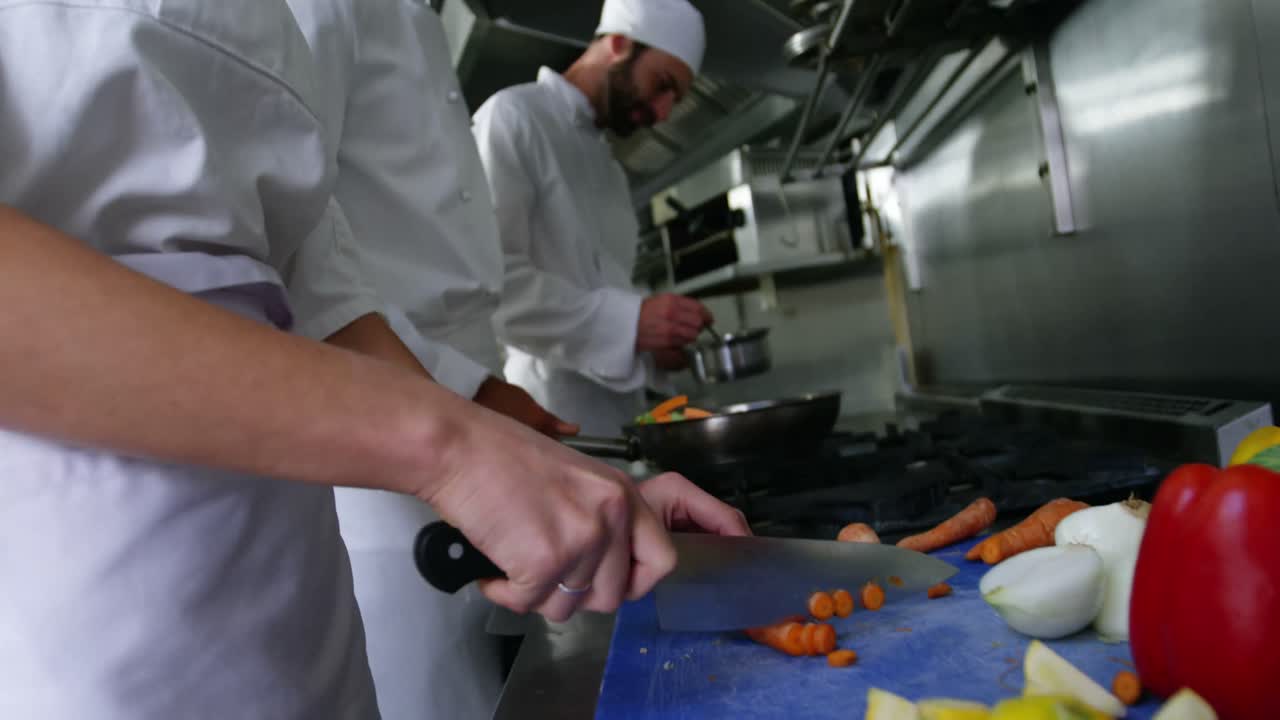 Team of chefs chopping vegetables and preparing food