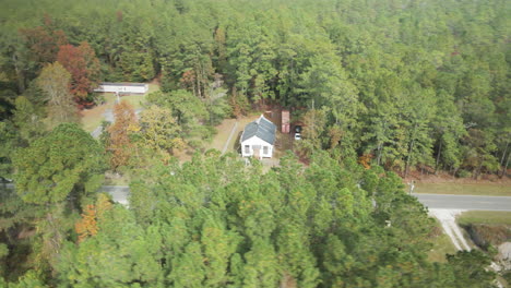 cabin in wood needing restoration orbiting aerial shot