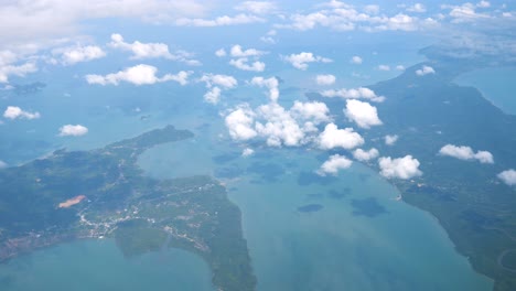 the airplane is flying over islands in thailand