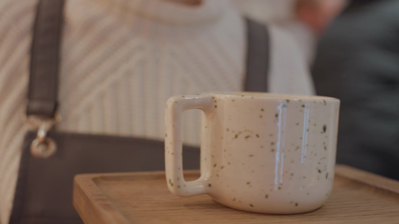 Barista Serving Coffee Mug to Customer in Cafe