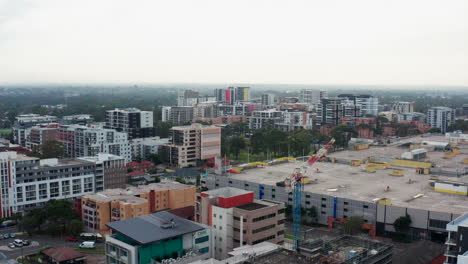 Aerial-drone-shot-flying-around-some-construction-work-and-crane-in-Liverpool-city-centre,-Sydney-Australia