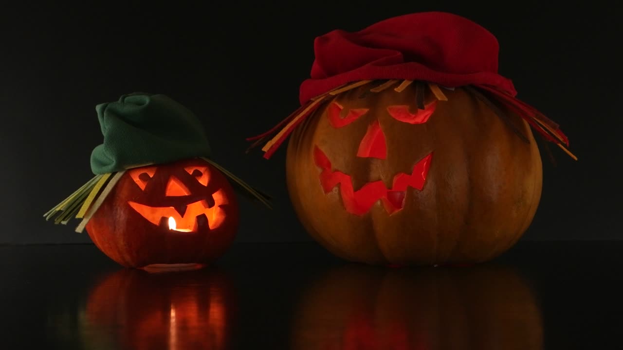 dos calabazas de halloween en los sombreros, fondo negro, vacaciones de halloween