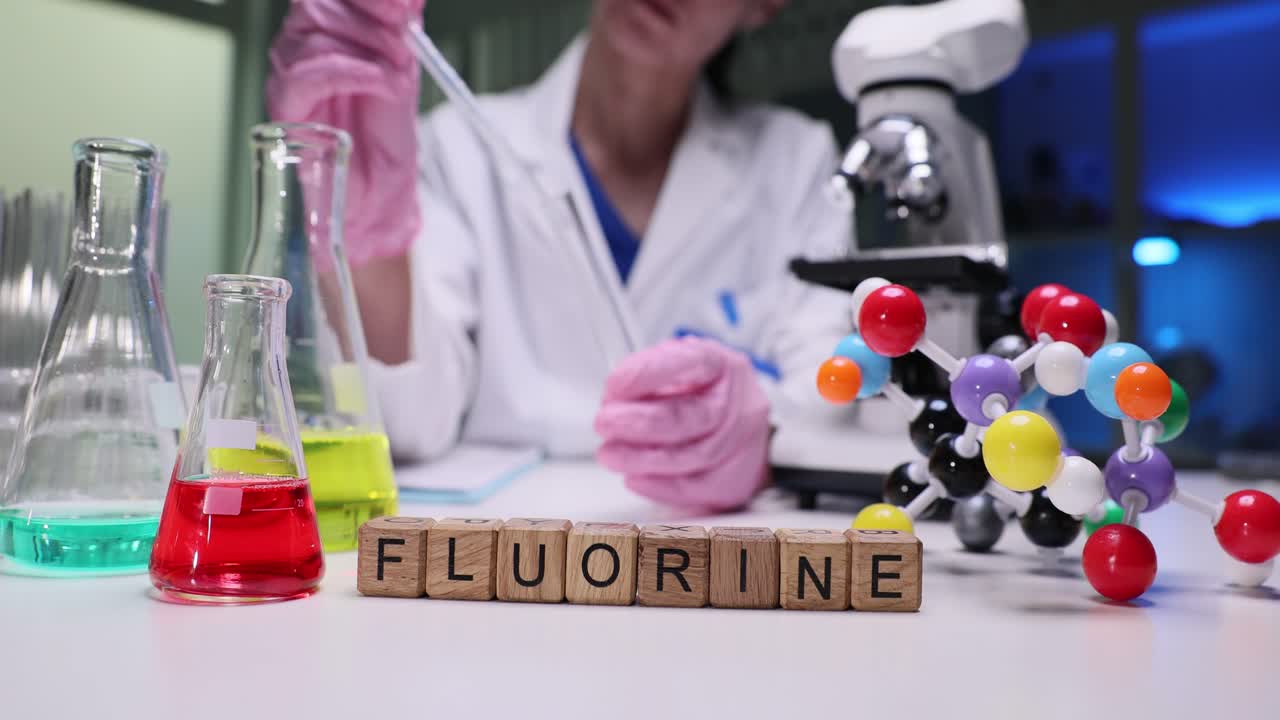 Scientist conducting a chemistry experiment with fluorine in a laboratory