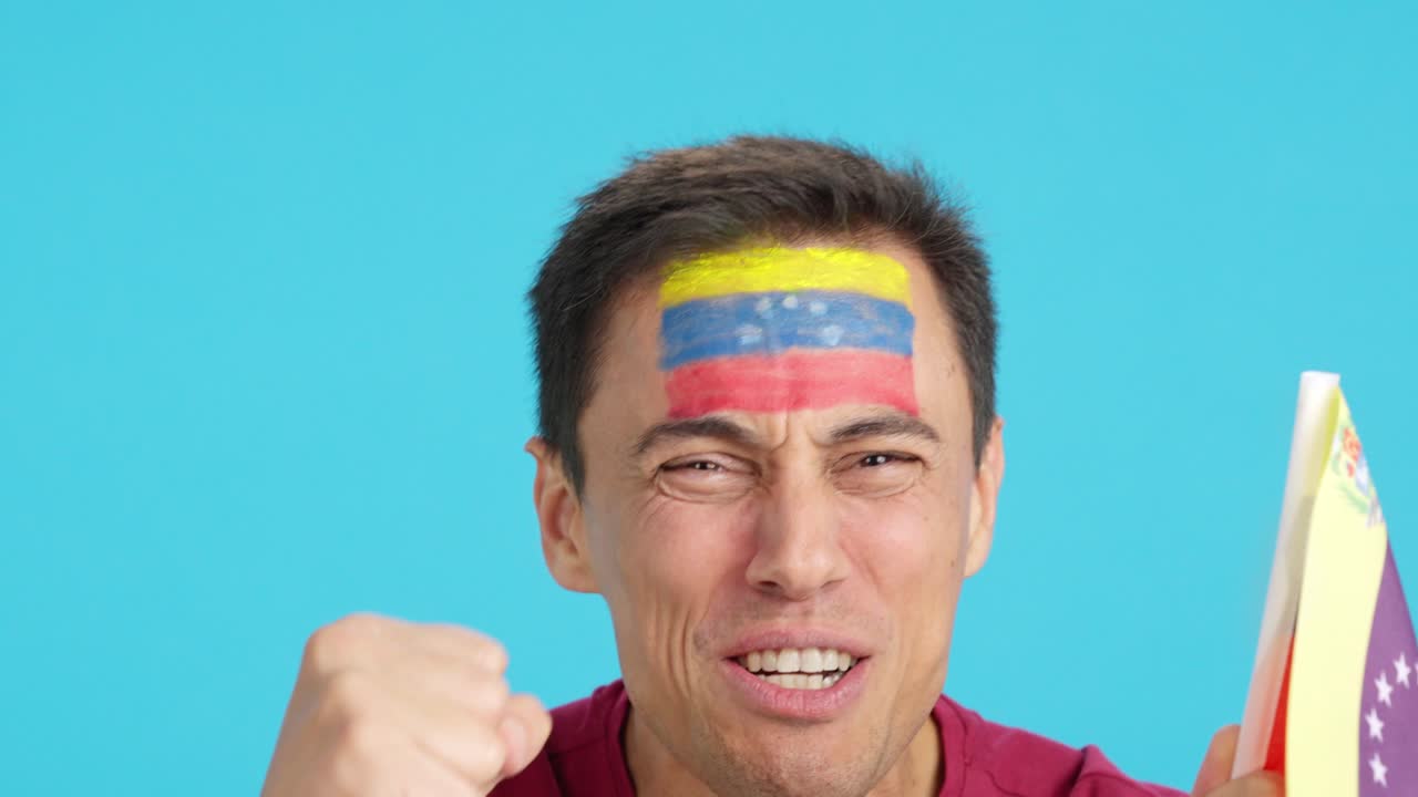 Close up of a man supporting venezuelan team