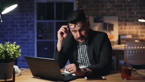tired businessman working late at night