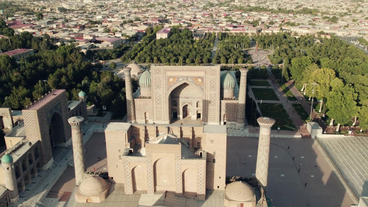 Aerial view of The Registan Square, Ulugh Beg Madrasah, TilyaKori Madrasah and Sherdor Madrassah architecture lit with sunlight