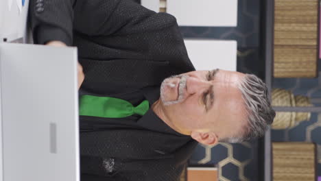 vertical video of unhappy and bored working businessman.