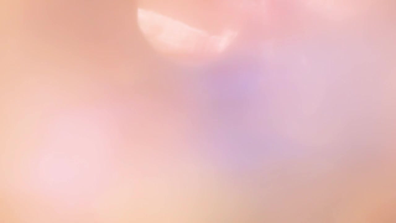 Soft Light Leak Transition with Warm Pink and Orange Hues