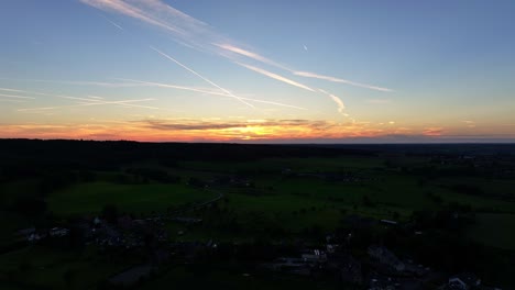 Peaceful-and-moody-skyline-of-colours-above-dark-countryside-buildings