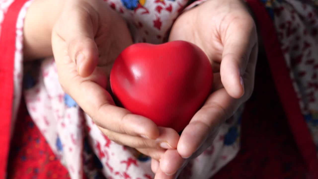 빨간 심장을 들고 있는 손