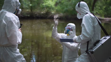 environmental scientists testing water quality in a river
