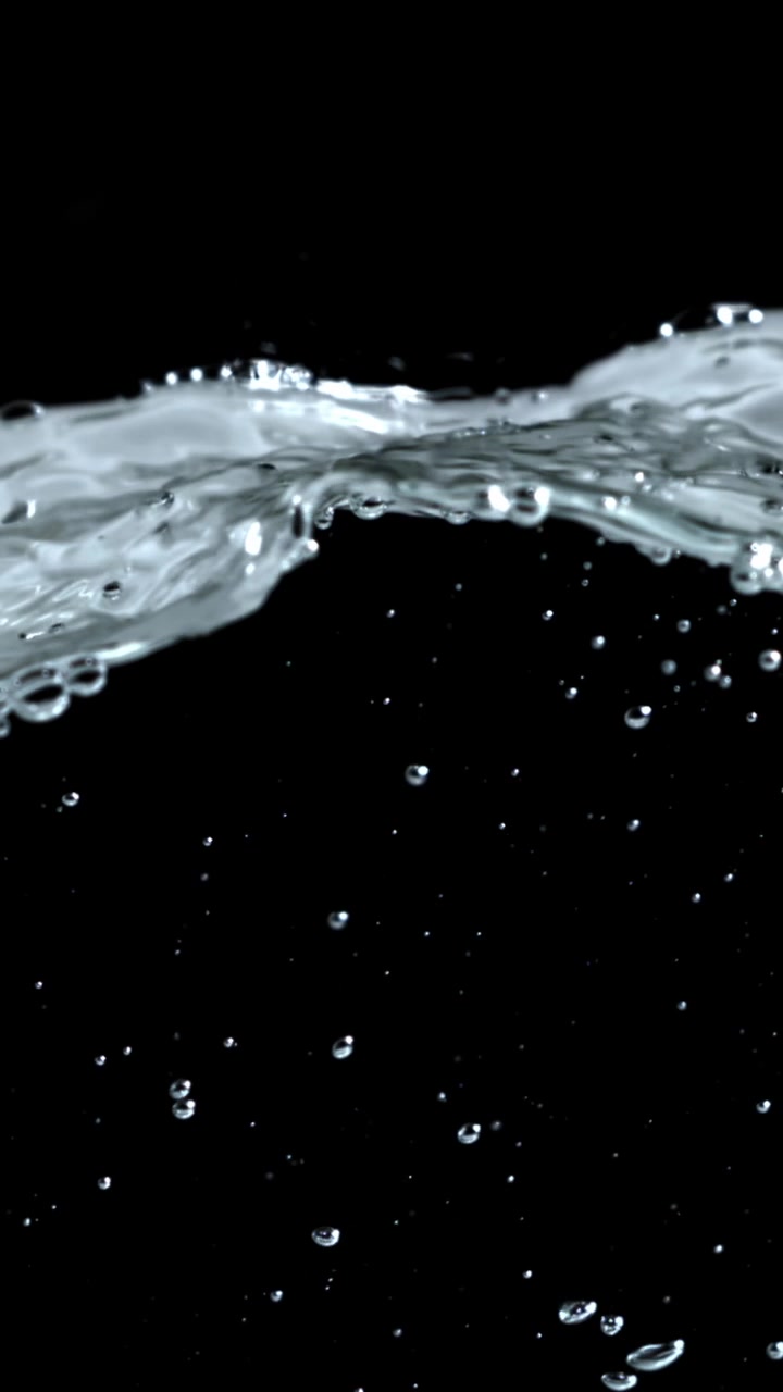 Clear Water Surface Rippling with Bubbles on Black Background