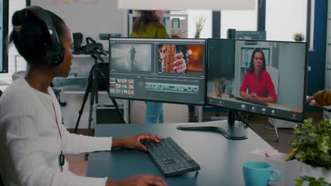 african woman editor with headset talking during online conference