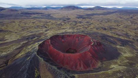 aerial view of a striking red volcanic crater