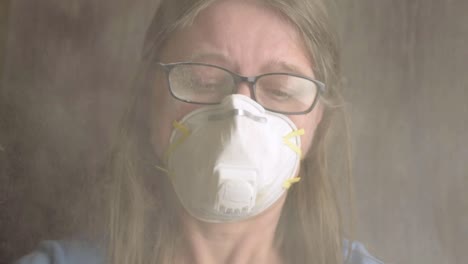 head shot of woman wearing disposable dust mask in toxic environment