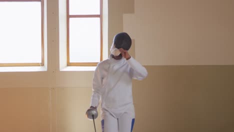 Female-fencer-athlete-during-a-fencing-training-in-a-gym