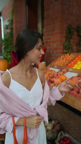 woman shopping for fruit at a market