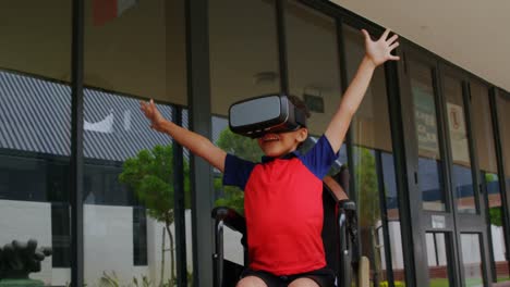 front view of disabled african american schoolboy using virtual reality headset in school corridor 4