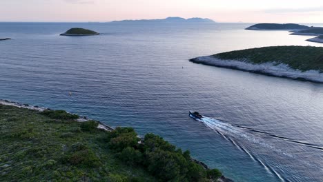 aerial: boat sailing on adriatic sea during the day in hvar, croatia, tracking drone shot