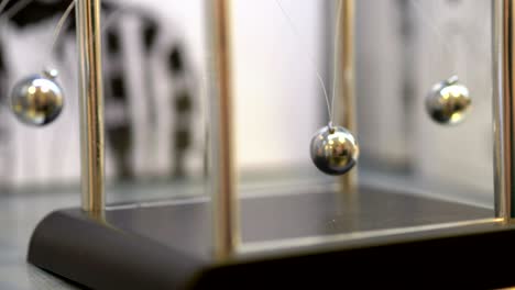 pendulum with swinging metal spheres in 4k slow motion 60fps