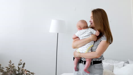 happy loving family. mother playing with her baby in the bedroom