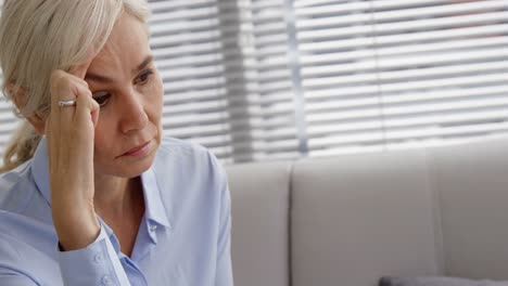 sad woman thinking and touching her head