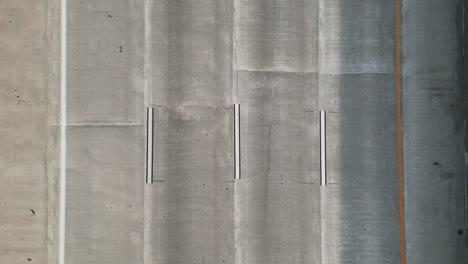 Aerial-View-of-Cars-Driving-on-4-Lane-Highway-from-Above