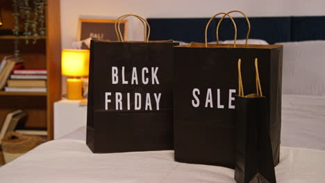 black friday shopping bags on bed