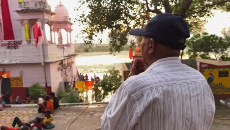 man offering pooja at mandir