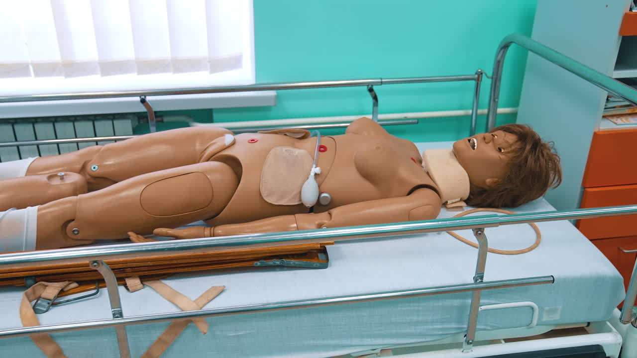 Female dummy in hospital bed. Plastic mannequin for medical experiences in studying room for teaching students in medical university. Faculty of health.