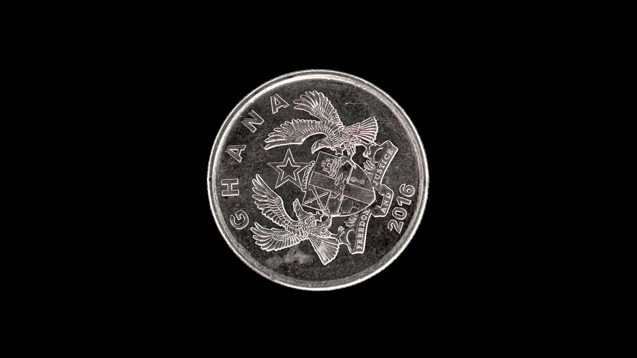 Ghana 2016 10 pesewas coin obverse with national arms rotating on black background