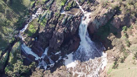 Reverse aerial view looking directly down over Nigretta Falls, along the Wannon River, near Hamilton, Victoria, Australia. June 2023.
