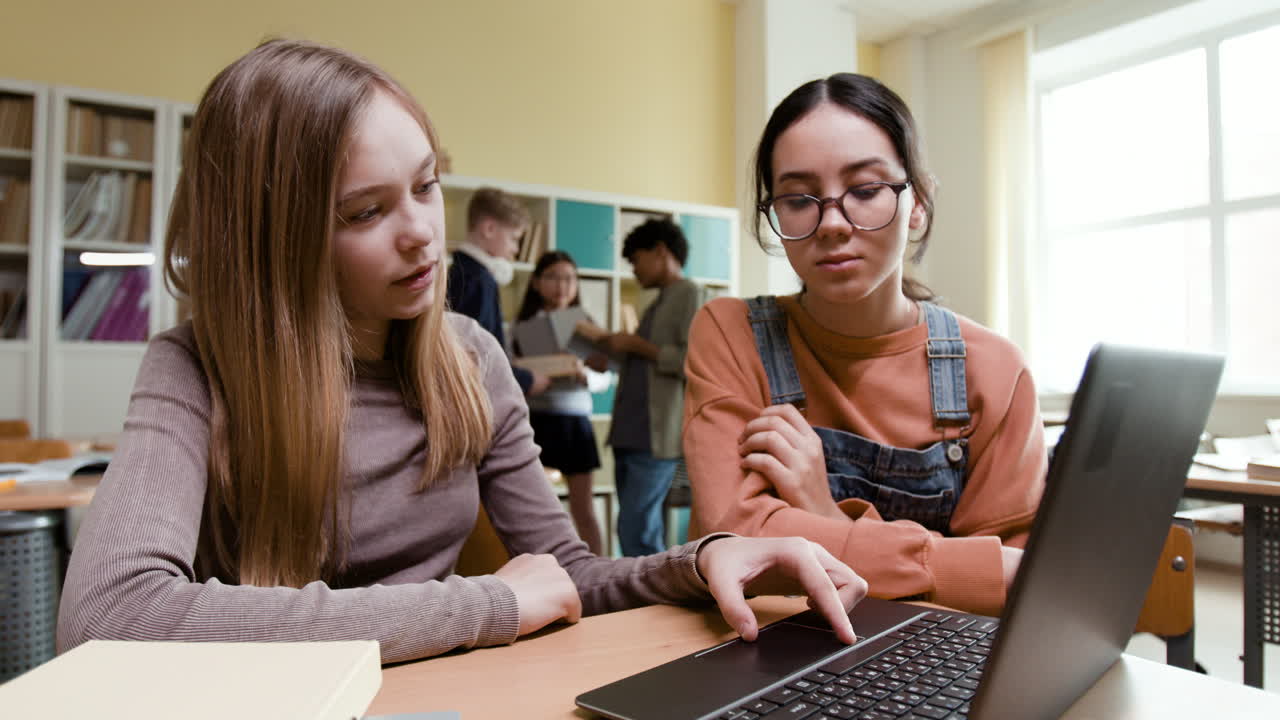 Students collaborating on a laptop in a classroom